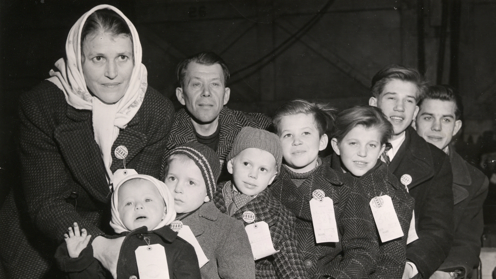 A displaced Ukrainian family waiting in a New York reception center in the late 1940s.